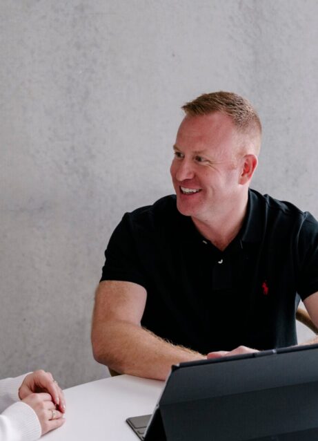 Photo of Lifestyle Finance Group Team Mick sitting with client on ipad for home loan meeting