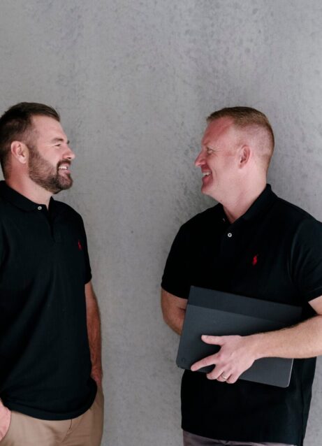 Photo of Lifestyle Finance Group Team Nick and Mick standing in front of cement wall